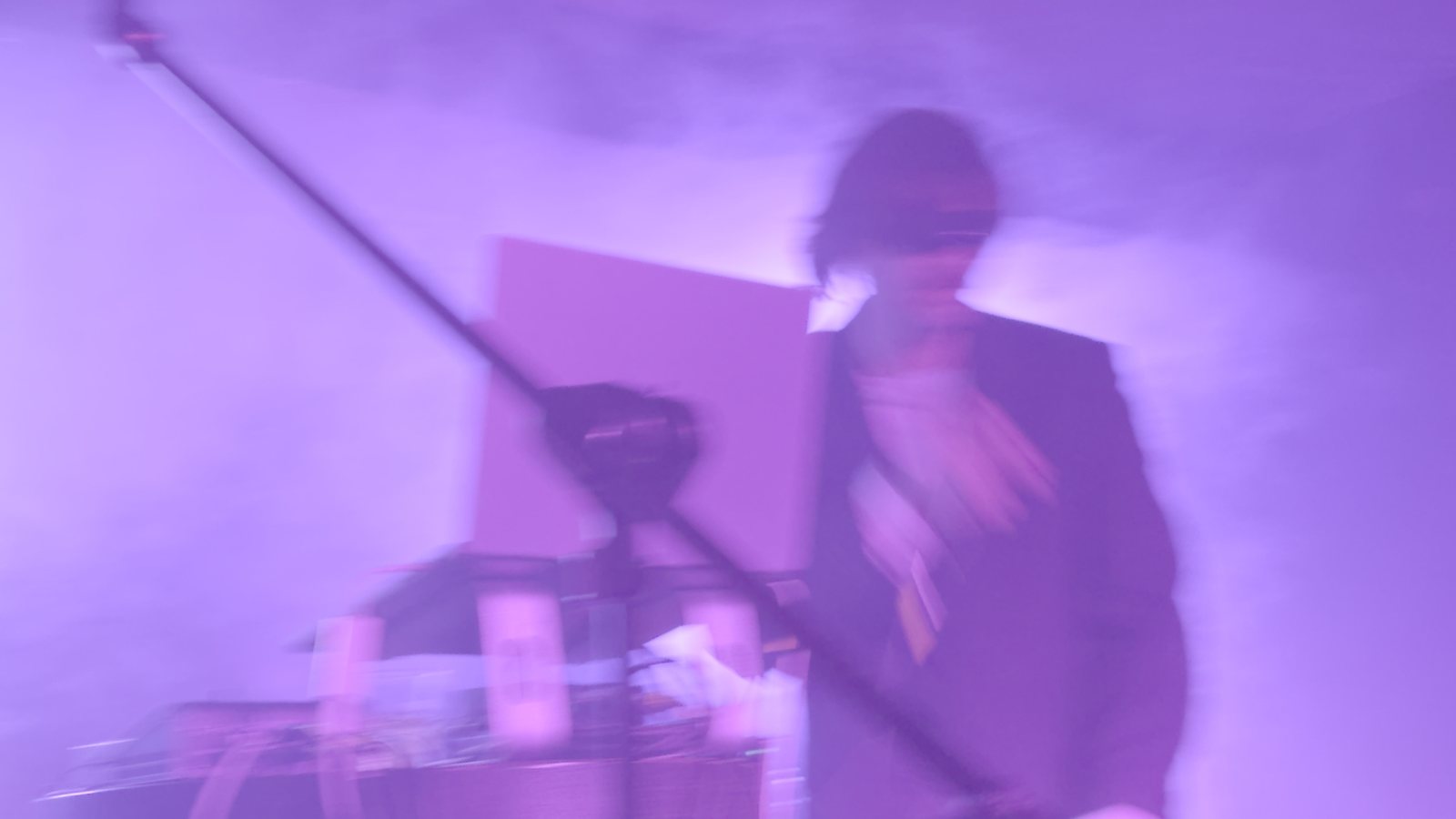 Performer at the microphone under violet light
