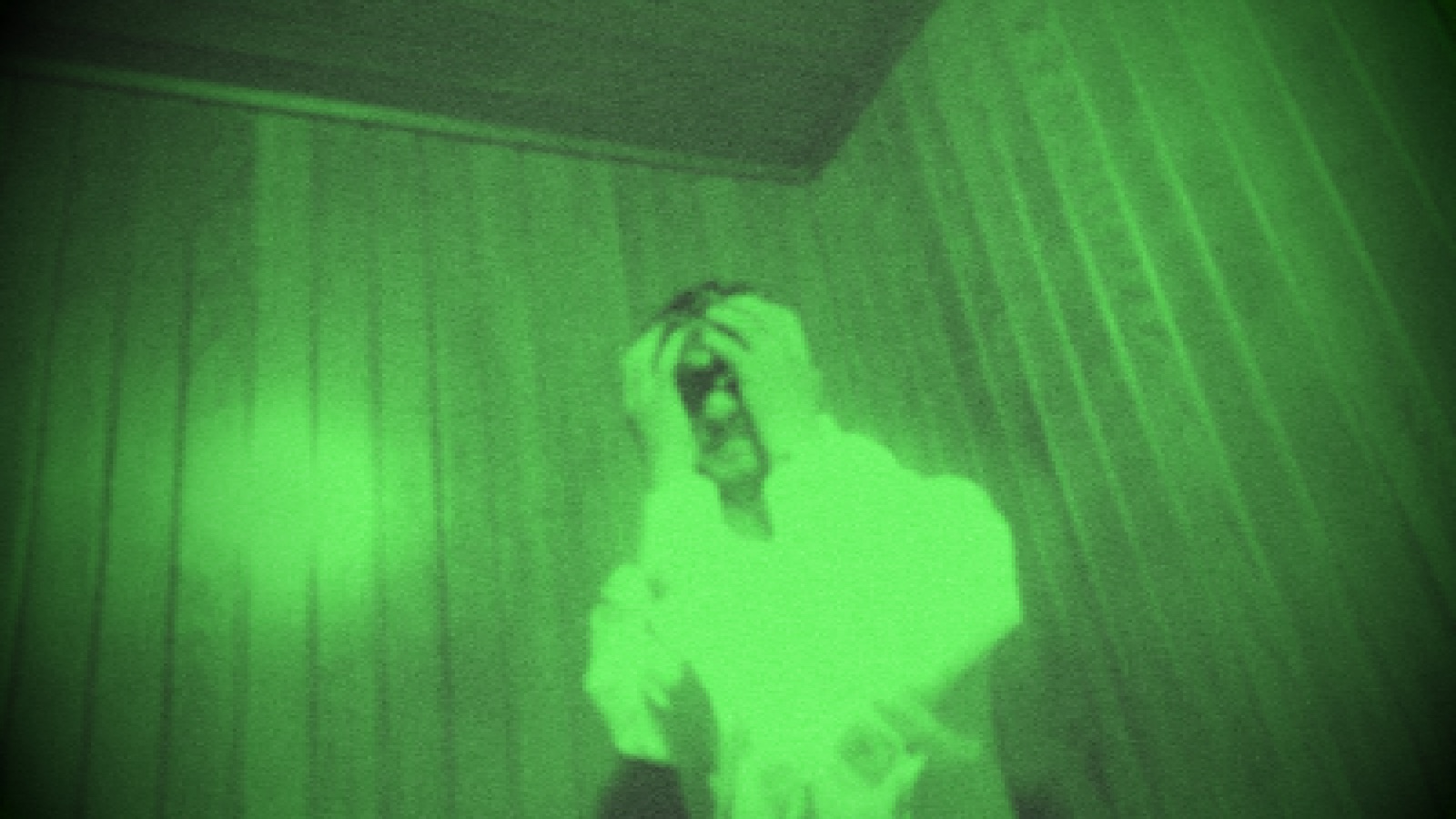 Green night-vision still from the video