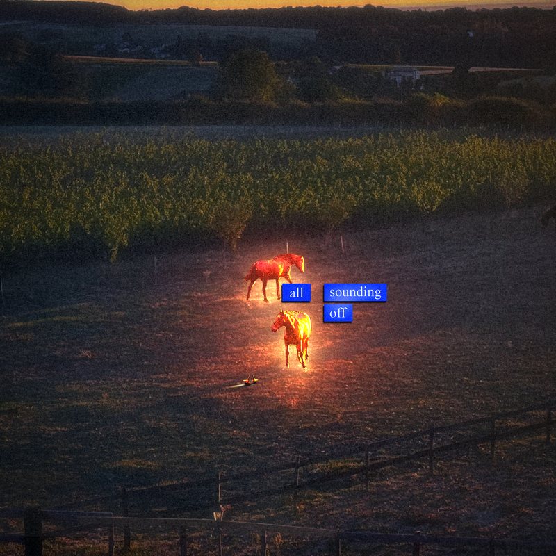 Two glowing horses in a dark field at dusk with small blue title labels